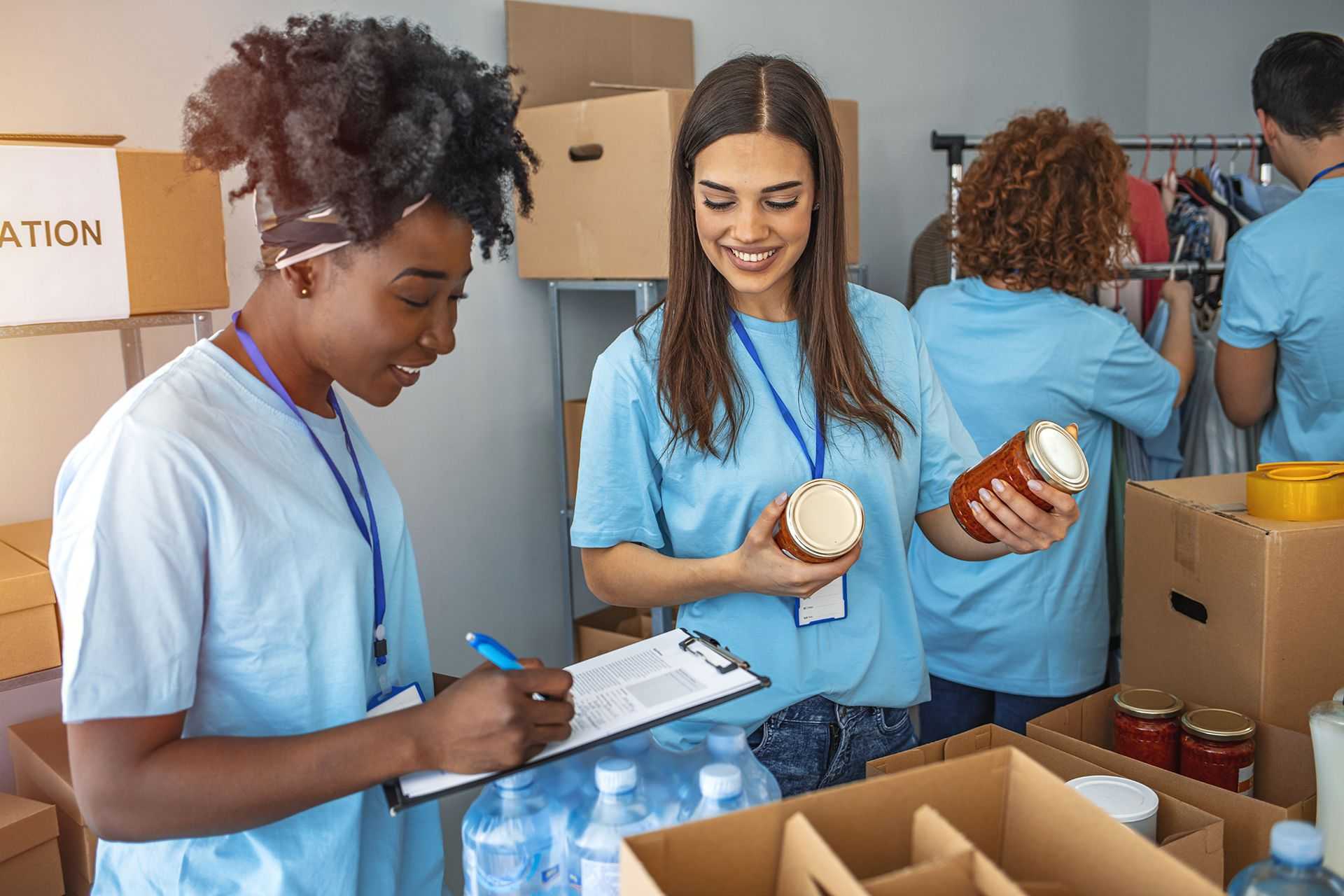 Team members sorting boxes of food for a community outreach charity event.