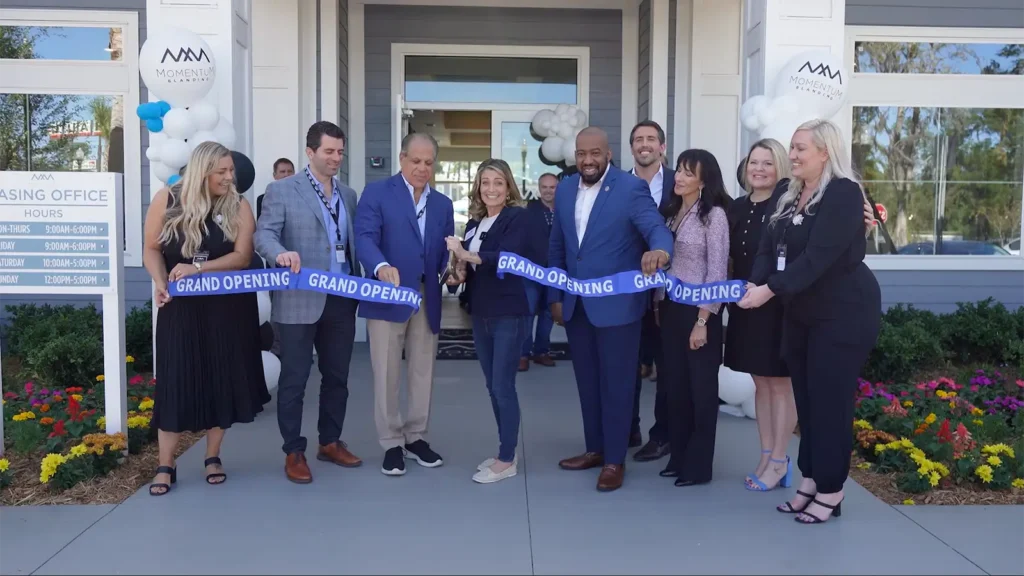 Leaders from Rentyl Apartments & Homes, Falcone Group, the city of Jacksonville, and Duvall County cut a ribbon at the Momentum Blanding Grand Opening